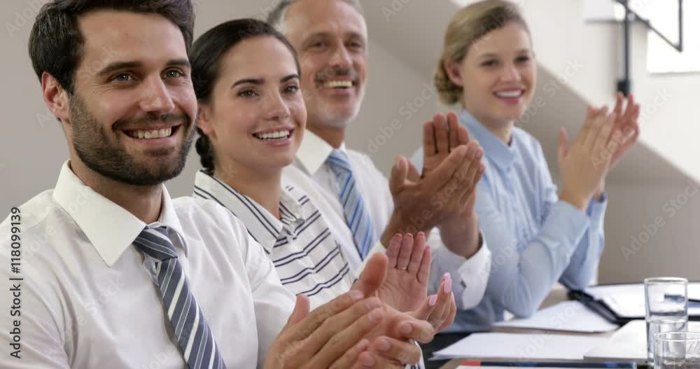 Business people applauding together at work Business people applauding together at work