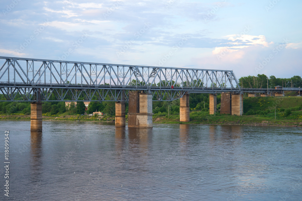 Railway bridge over the Volkhov river in the summer dusk. Volkhov, Leningrad region Railway bridge over the Volkhov river in the summer dusk. Volkhov, Leningrad region