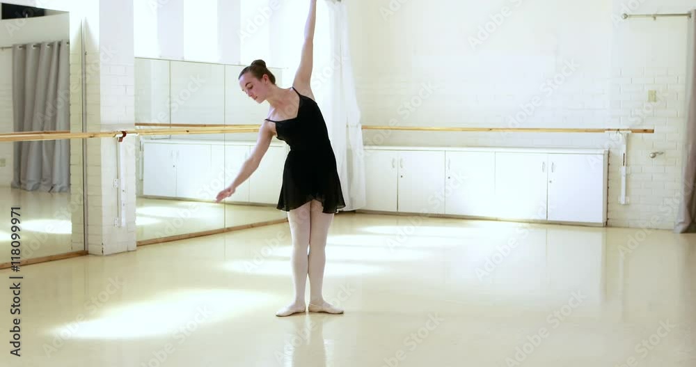 Ballerina is doing exercises in dancing hall Ballerina is doing exercises in dancing hall
