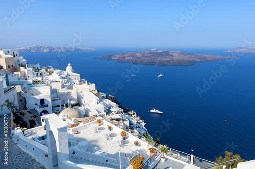 White houses of Fira, Santorini with Santorini's famous volcano in the background