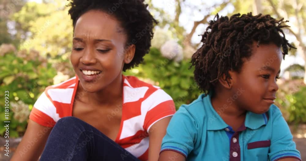 Portrait of cute family is sitting in a park
