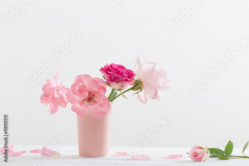 Pink roses in vase  on white background