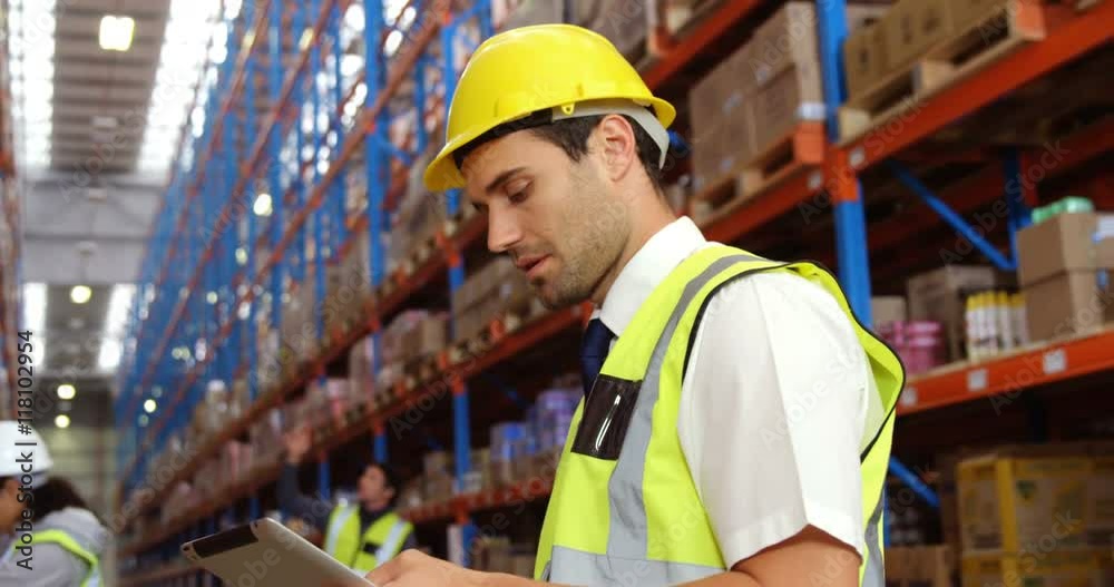 Warehouse worker using his tablet Warehouse worker using his tablet