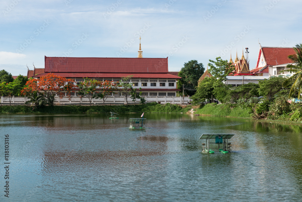 The thai temple near lake with water turbine by solar cell The thai temple near lake with water turbine by solar cell