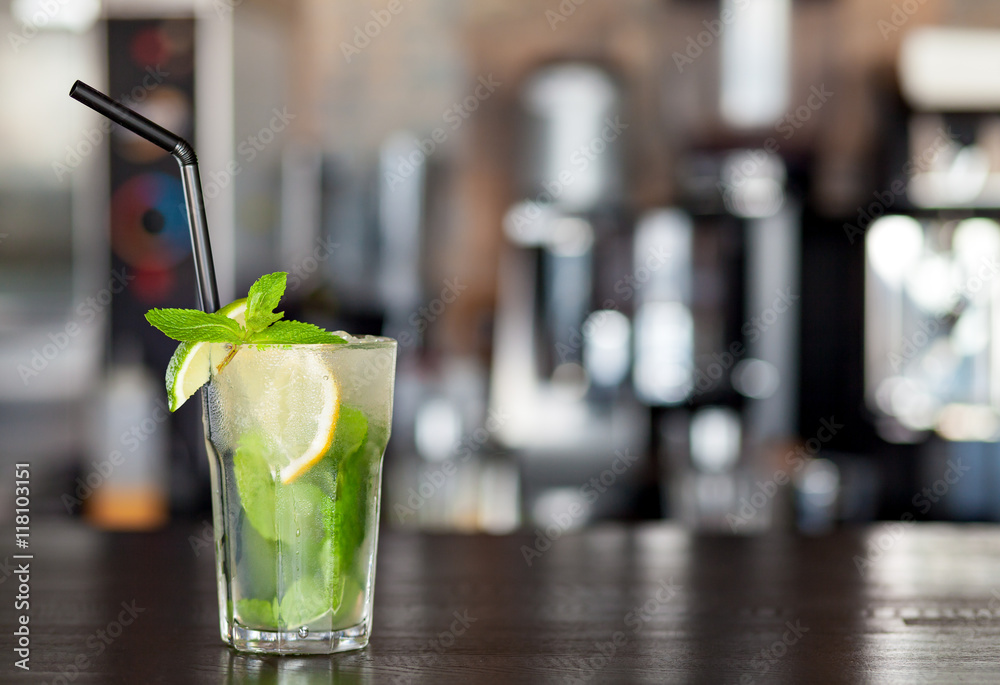 Lemonade with lime, mint on the background of the bar in the cafe. Summer drink. Lemonade with lime, mint on the background of the bar in the cafe. Summer drink.