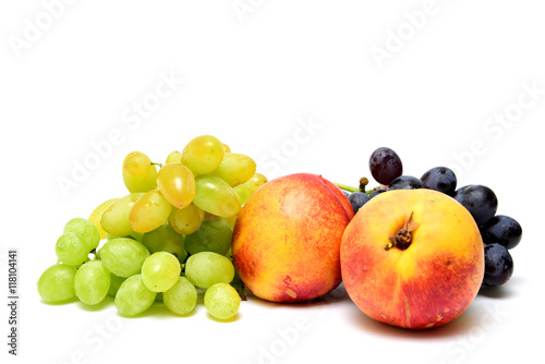 Clusters of grapes and nectarines on a white background.