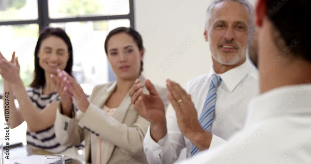 Business people applauding together at work Business people applauding together at work