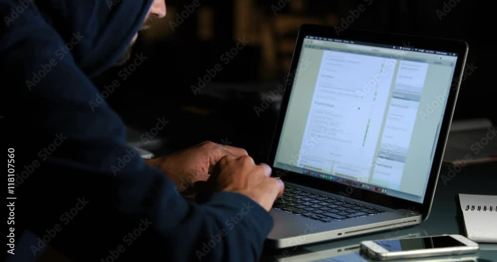 Hacker using laptop at night Hacker using laptop at night
