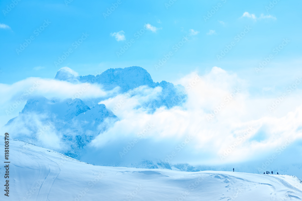 beautiful winter landscape of Dombaj with clouds and descent from the mountain, Russia