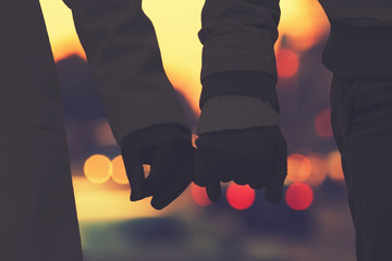 Silhouettes of a couple with de-focused city lights.