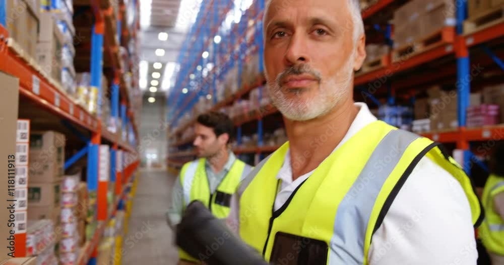 Smiling worker scanning boxes