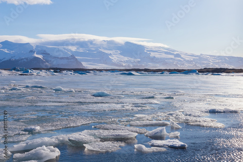 Beautiful ice melt on the lagoon with mountain background, Iceland winter natural landscape