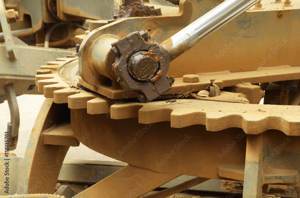 close up of large grader gear and grease on join hydrolic lifter close up of large grader gear and grease on join hydrolic lifter