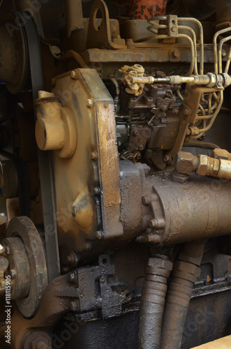 Old engine of grader car with oil engine leak