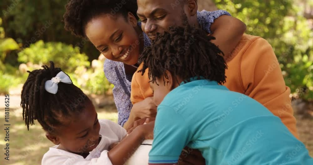 Close up of cute family is playing rugby in a park Close up of cute family is playing rugby in a park
