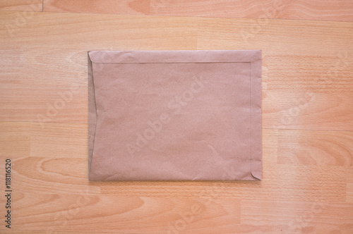 Old brown envelope on wooden table floor background