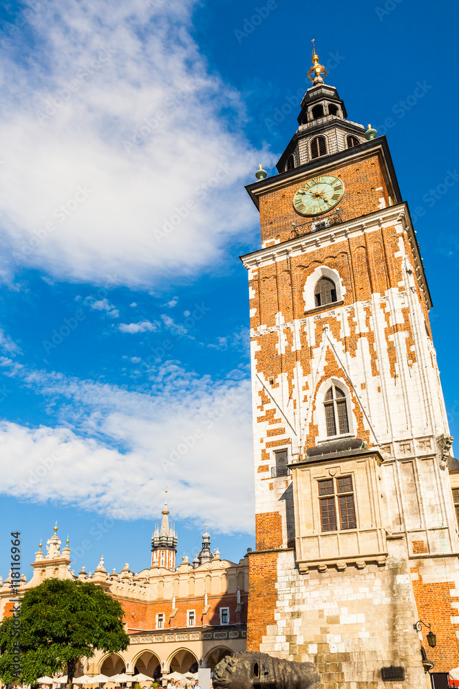 Beautiful high gothic town hall tower with clock in the main Market Square in Cracow, Poland. Travel Europe.