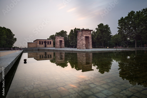 Illuminated templo de Debod and reflection at sunset in Madrid