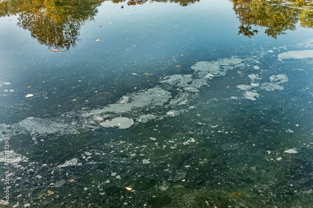 Dirty oil stains on the surface of the lake water polluted as a