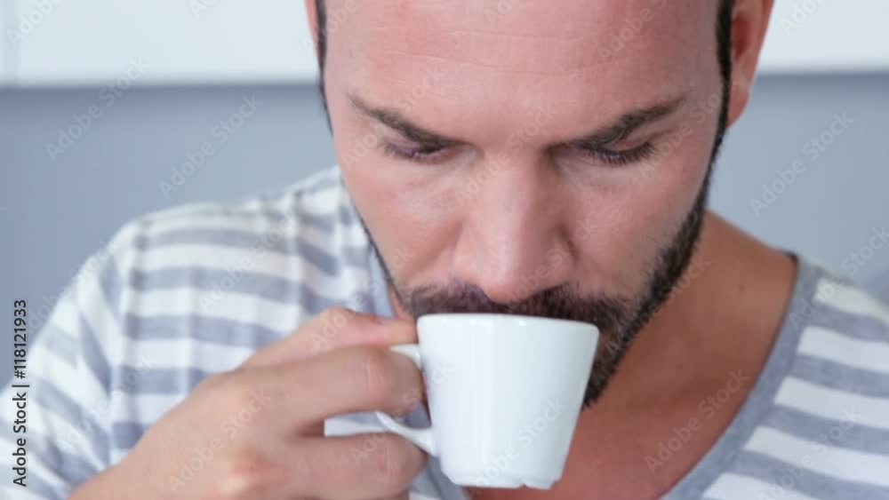 Man drinking an espresso and using tablet Man drinking an espresso and using tablet