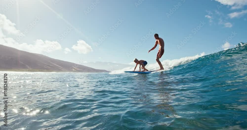 Father and son having fun surfing together, summer lifestyle family time