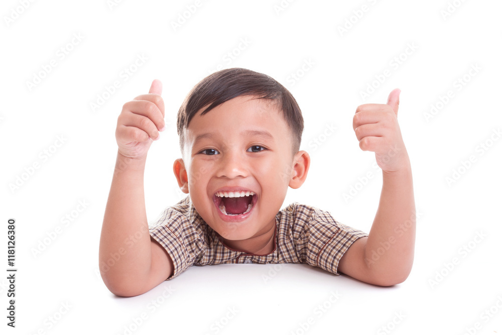 Portrait of cheerful boy showing thumbs up gesture, on white background