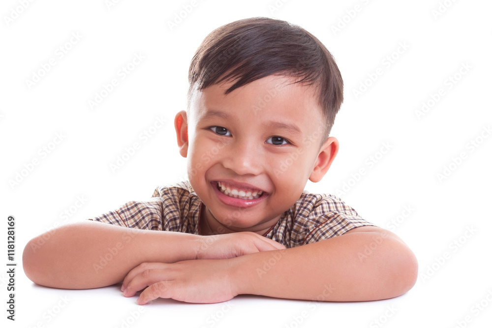 Cute boy is sitting at the desk, on the white background Cute boy is sitting at the desk, on the white background