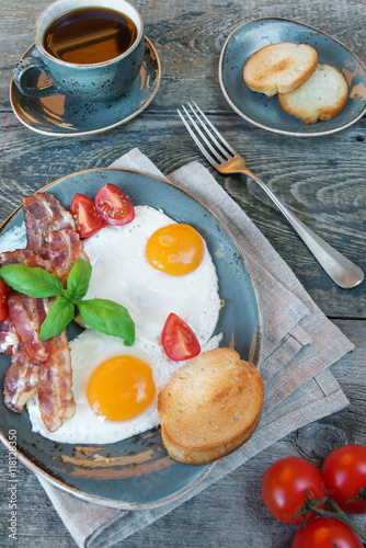 Fried eggs,  bacon, tomato,...