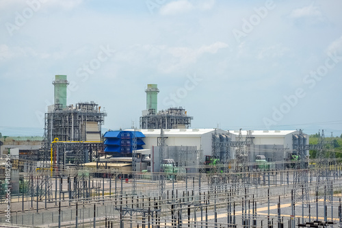Combine cycle power plant with green field and clear sky
