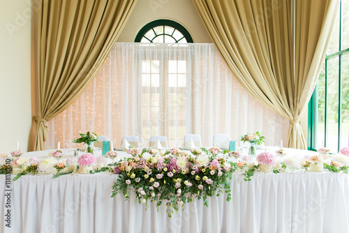 Indoors wedding reception venue with d  cor  selective focus on flowers