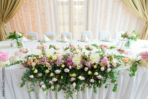 Indoors wedding reception venue with décor, selective focus on flowers
