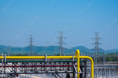 Natural gas piping in power plant with high volt pole background