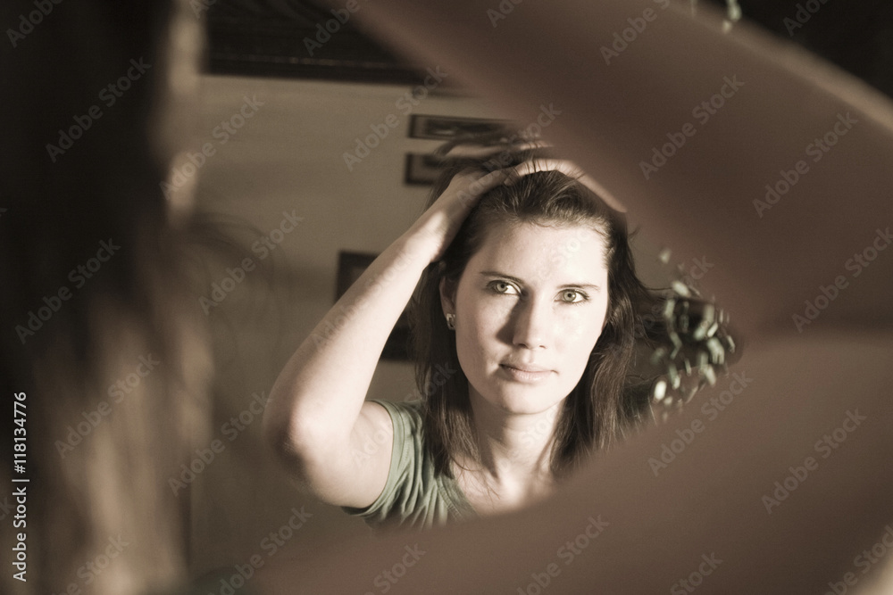 Fototapeta premium Woman looking in a mirror