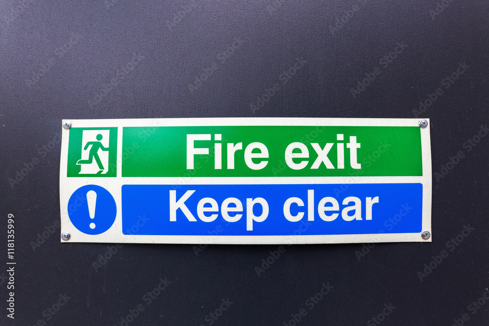 fire exit sign on black wall