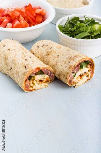 Wrap with tomato, lettuce, harissa and hoummous.