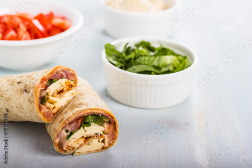 Wrap with tomato  lettuce  harissa and hoummous.