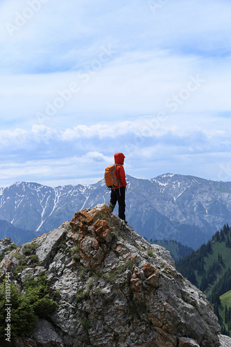 young woman hiker hiking at beautiful mountain peak