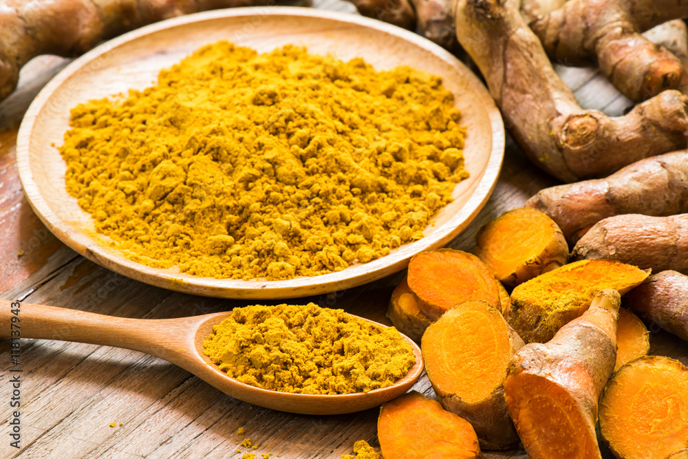 Fresh turmeric roots with turmeric powder Fresh turmeric roots with turmeric powder