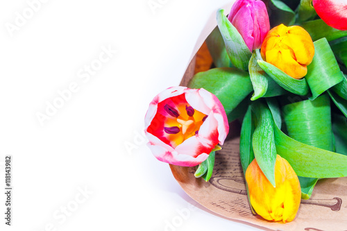 the bouquet of tulips is wrapped in a paper isolated on a white