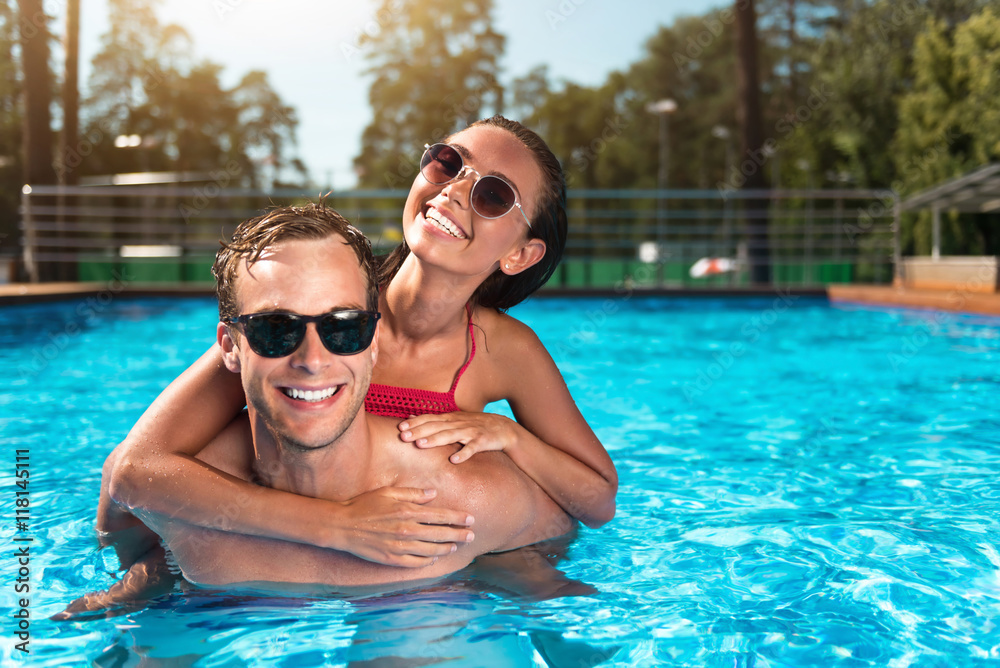 Cheerful couple swimming in a pool Cheerful couple swimming in a pool