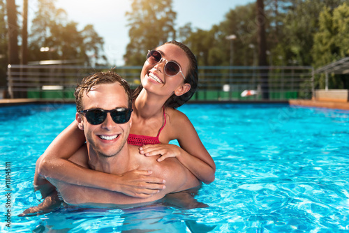 Cheerful couple swimming in a pool