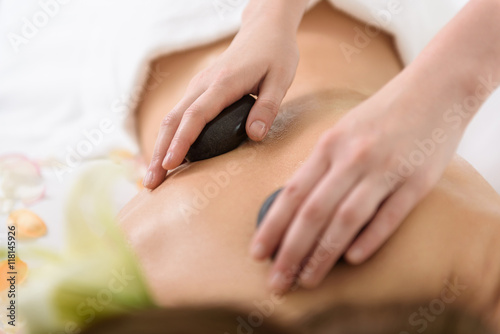 Skillful beautician pampering female body