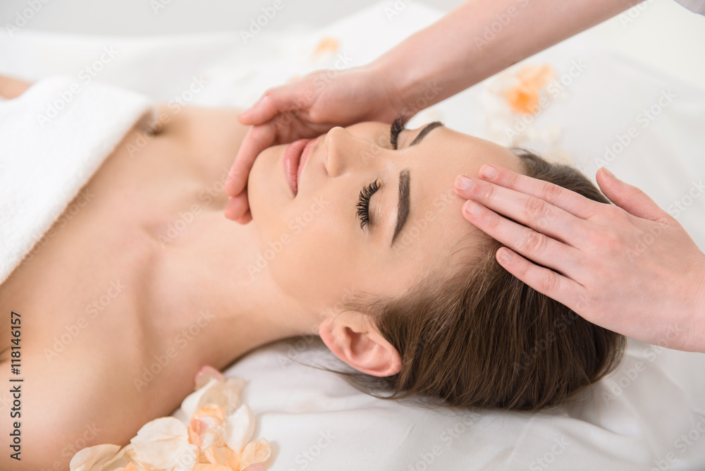 Joyful young woman getting treatment at wellness center Joyful young woman getting treatment at wellness center