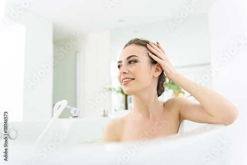 Cute young woman bathing in water