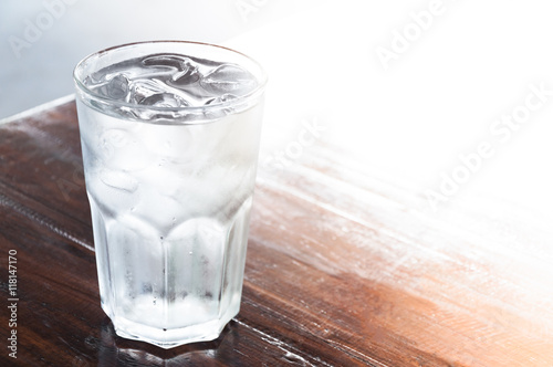 glass of water with ice on wooden table , clean water,drinking water