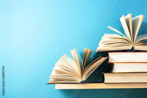 Open book, hardback books on wooden table. Education background. Back to school. Copy space for text.