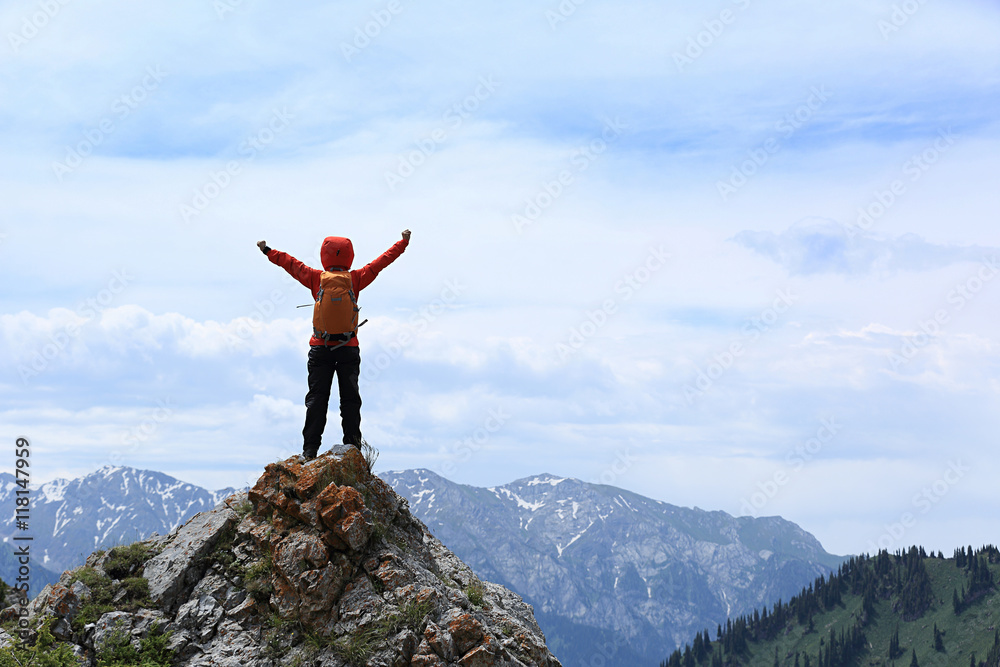 successful young woman backpacker open arms on mountain peak successful young woman backpacker open arms on mountain peak