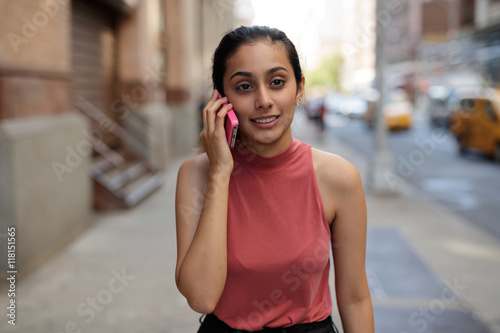 Young woman in city talking on cell pohne