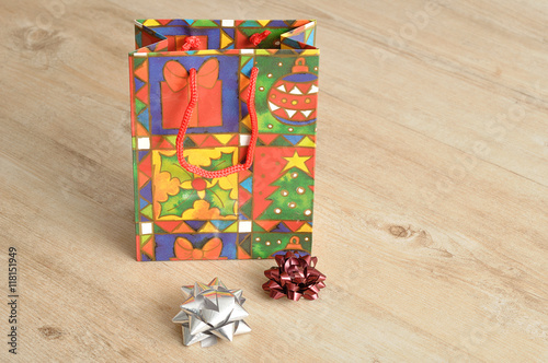 A colorful christmas gift bag with bows