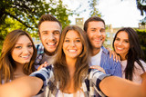 five happy best friends with toothy smile making selfie photo